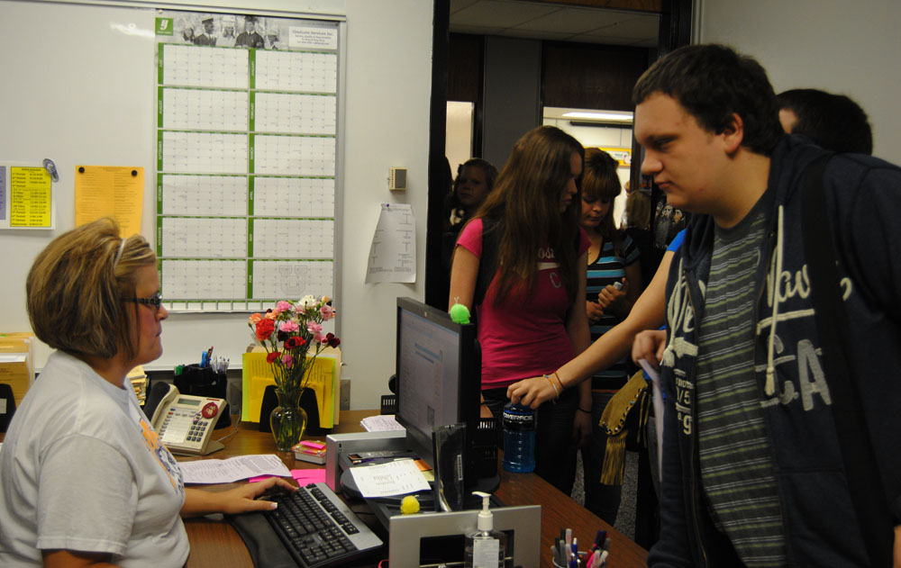 Senior Ben Wilcoxson gets his final schedule of his high school career from Guidance Secretary Sara Parks.