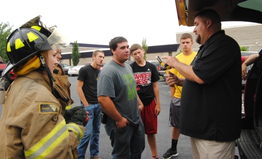 Fire instructor Dutch Parks explain gear to students in the new fire safety class. 