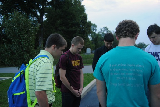 Freshman Connor Henderson, Senior Ben Goble, Sophomore Judah Gehl and Junior Daniel Hutcheson gather together to pray this morning at See You at The Pole. 