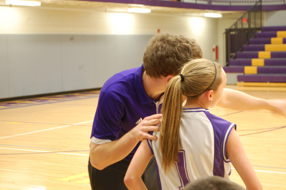 Coach Key and seventh grader Madison Street have a talk when she comes in from the court. 