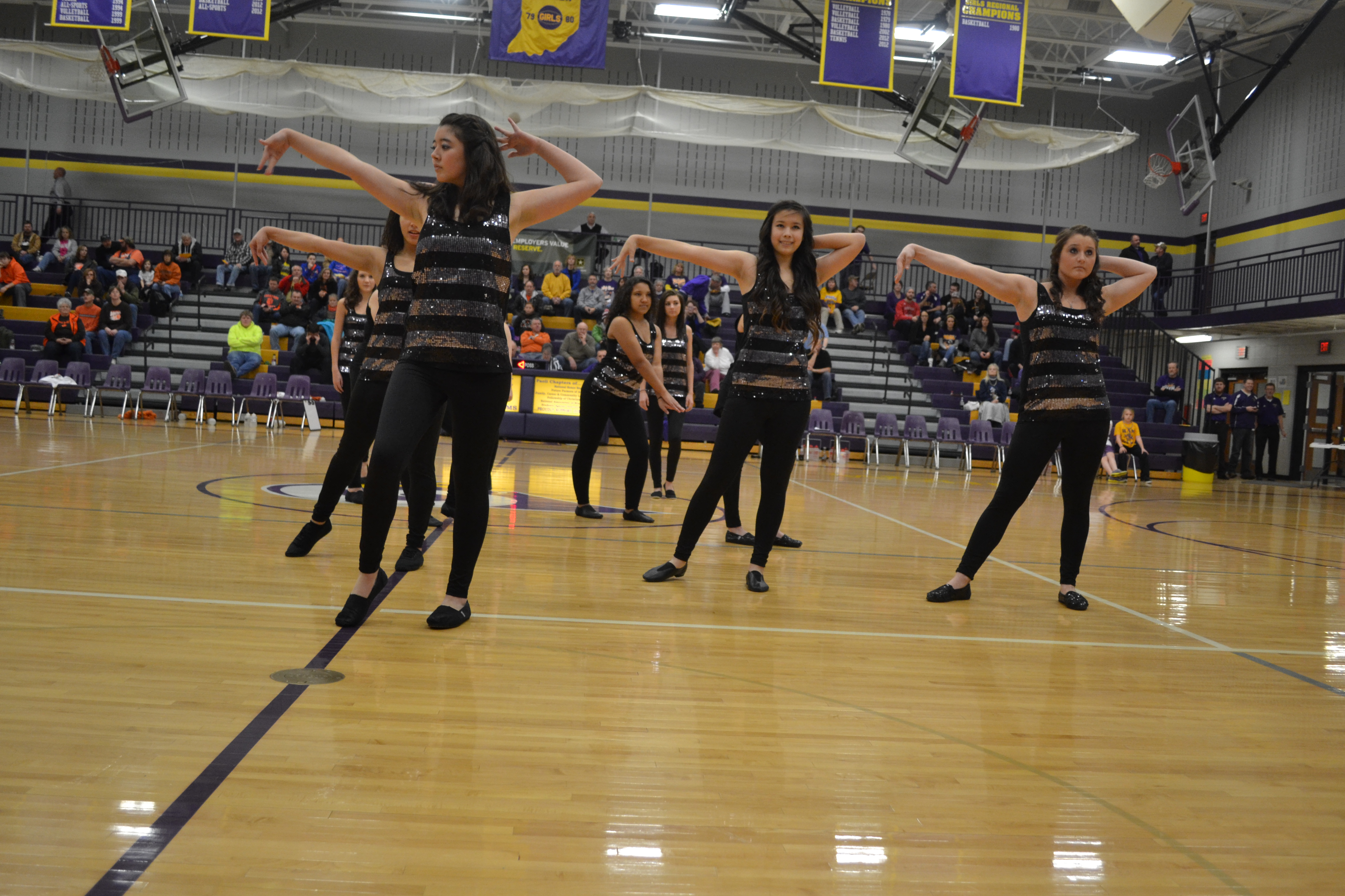 Junior Victoria Kesterson, freshman June Hobson, and senior Kayli Tolen dance during the Flygirls' first dance performance. The girls' performance was on January 18th between the girls Junior Varsity and Varsity games.