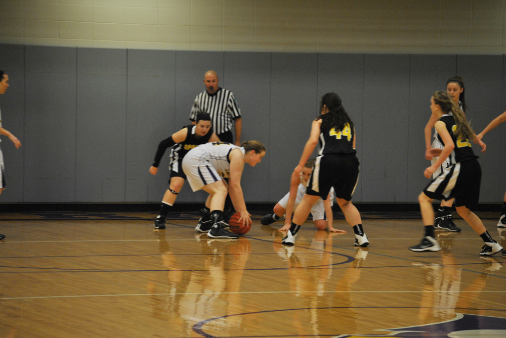 Junior Rachel Cadle bends down to grab the ball, and passes it to a teammate.