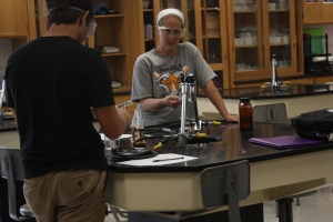 Mrs. Higgins and student Mason Deaton doing experiments in General Chemistry. Mrs. Higgins has to burn different elements. ¨We do a flame test showing how different 