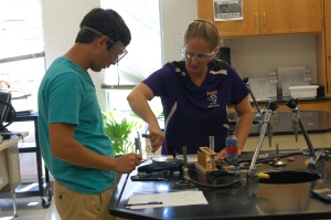 Mrs. Higgins and senior Mason Deaton test different elements burning. Deaton is the only student that attends this chemistry class, ¨We were showing how different elements burn in different colors,¨ said Mrs. Higgins.